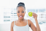 Attractive woman holding green apple