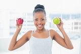 Attractive woman holding green and red apples