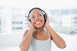 Peaceful woman listening to music with headphones