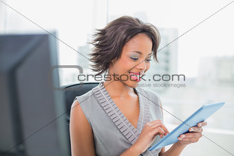 Happy businesswoman using tablet pc
