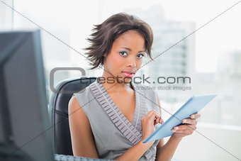 Pretty businesswoman using her tablet pc