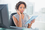 Businesswoman using her digital tablet at desk