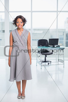 Smiling businesswoman standing in her office