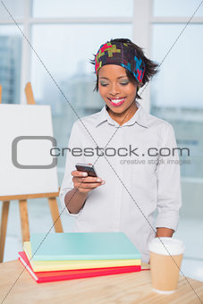 Smiling artist using her phone