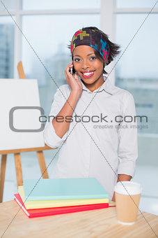 Happy artist talking on phone