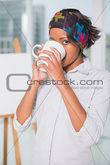 Artistic woman drinking a coffee