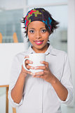 Artistic woman holding cup of coffee