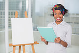 Smiling artistic woman holding sketchpad
