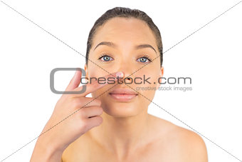 Woman pointing on her nose