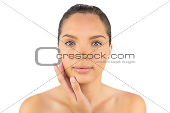 Cheerful woman touching her cheek