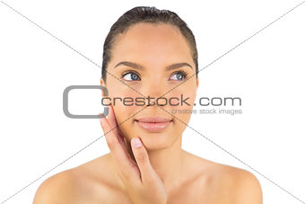 Smiling woman touching her cheek