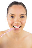 Happy woman brushing her teeth