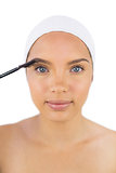 Sensual woman wearing headband using eyebrow brush