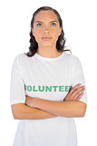 Brunette wearing volunteer tshirt with arms crossed