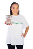 Smiling volunteer woman showing jar