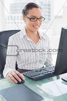 Cheerful businesswoman working on computer