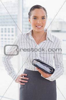 Pretty businesswoman holding her appointment calendar
