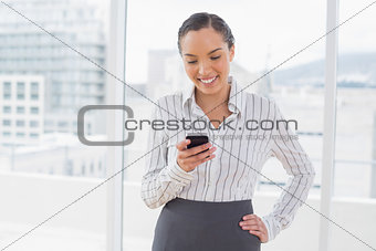 Happy businesswoman standing in her office