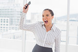 Offended businesswoman screaming and throwing her mobile phone