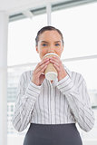Peaceful businesswoman drinking coffee