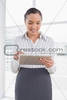 Pretty businesswoman using tablet