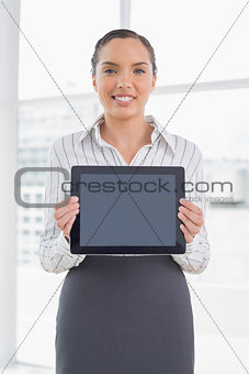 Smiling businesswoman showing tablet screen