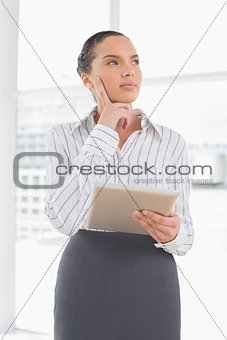 Confused businesswoman using a tablet pc
