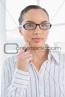 Thoughtful businesswoman wearing reading glasses