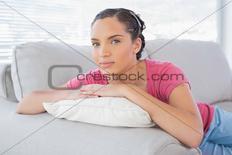 Attractive woman lying on sofa