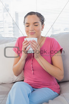 Woman on the sofa enjoying a coffee