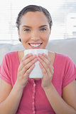 Portrait of smiling woman holding a cup of coffee