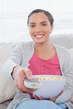 Attractive woman eating popcorn while watching tv