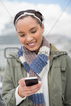 Smiling woman texting