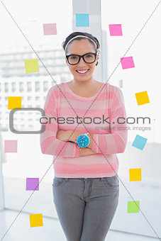 Happy woman with arms crossed in her creative office