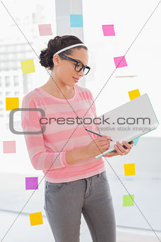 Concentrated attractive artist drawing on her sketchpad