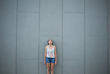 Woman standing in front of grey wall