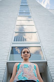 Attractive woman standing in front of a tall building