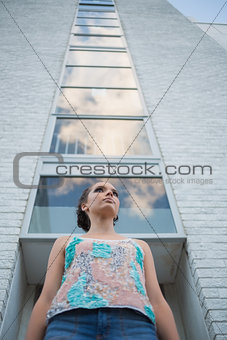 Pretty woman standing in front of a tall building