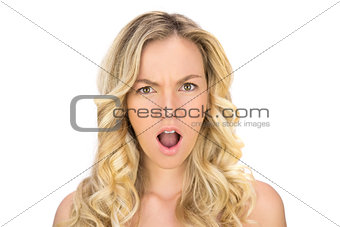 Shocked curly haired blonde posing