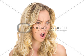 Offended curly haired blonde posing