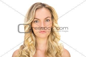 Serious curly haired blonde posing
