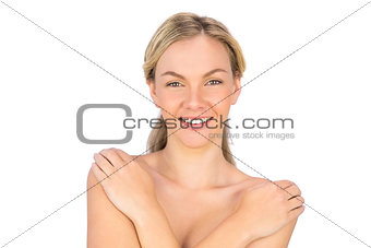 Smiling pretty nude blonde posing
