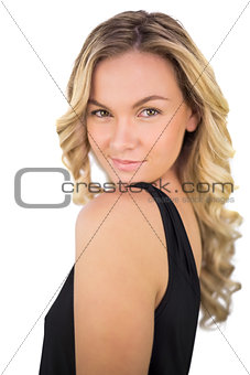 Smiling gorgeous blonde in black dress posing