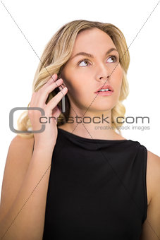 Pensive gorgeous blonde in black dress on the phone