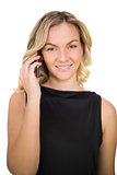 Cheerful gorgeous blonde in black dress on the phone
