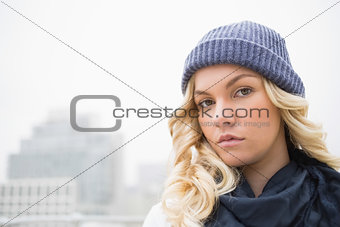 Gorgeous blonde in winter clothes posing outdoors