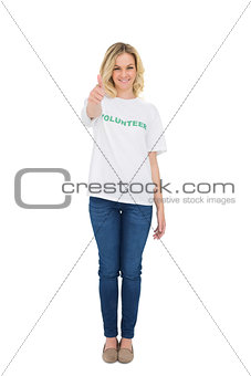 Happy blonde volunteer giving thumb up to camera