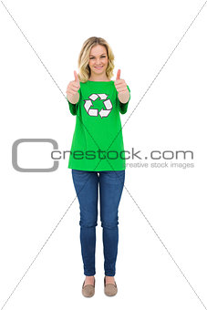 Smiling blonde environmental activist giving thumbs up to camera