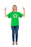 Happy blonde environmental activist pointing up