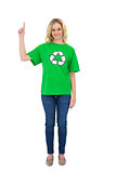 Smiling blonde environmental activist pointing up